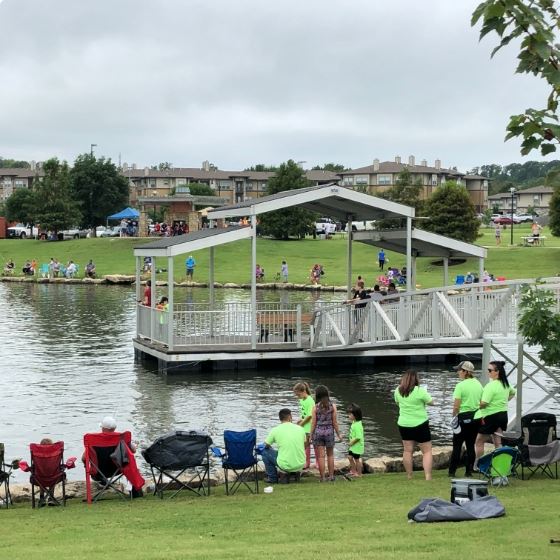 Spotlight People by a lake