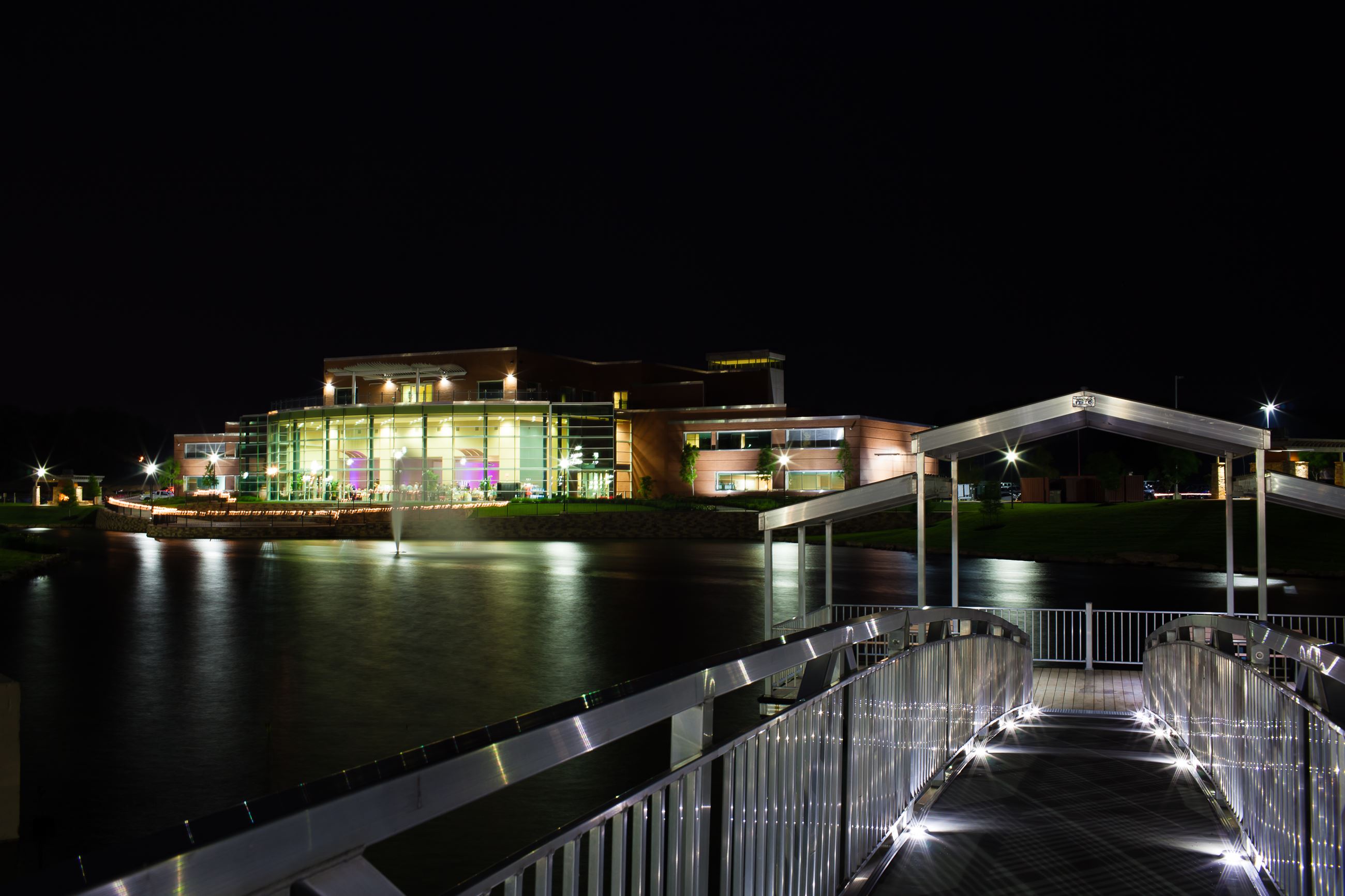 outside of conference center, pond, and dock at night